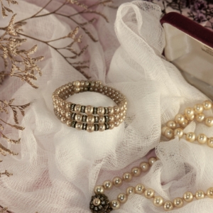 Elegant close-up of pearl jewelry arranged on delicate fabric, perfect for fashion and lifestyle themes.